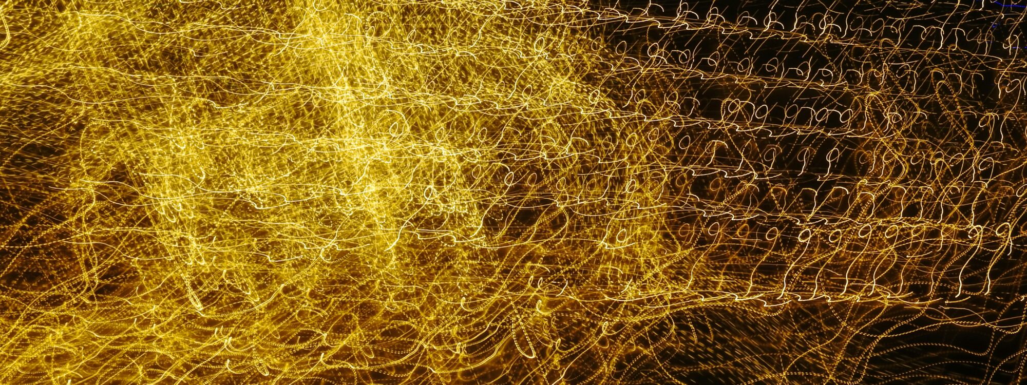 Photo by Debbie Ducic on Unsplash (https://unsplash.com/photos/a-blurry-image-of-yellow-lights-on-a-black-background-mtdcK0mb6WQ)