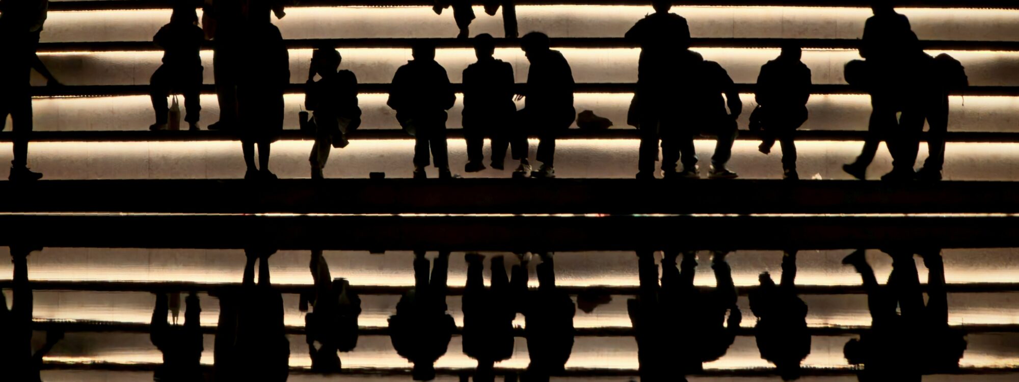 Photo by Wu Zhongyi on Unsplash (https://unsplash.com/photos/people-are-silhouetted-on-illuminated-stairs-6u5LNbycEwc)