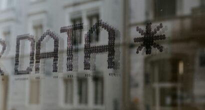 Photo by Claudio Schwarz on Unsplash (https://unsplash.com/photos/a-close-up-of-a-window-with-a-building-in-the-background-fyeOxvYvIyY)