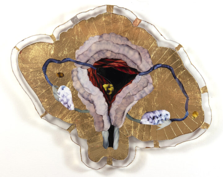 An artist's interpretation of a uterus. The main colour is gold.