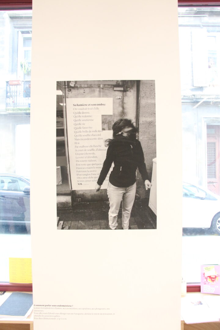 A photograph of a masked woman in front of a street poem.