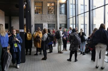 Conference attendees mingling during a coffee break