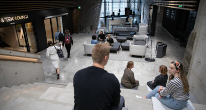 People sitting on steps inside a university building